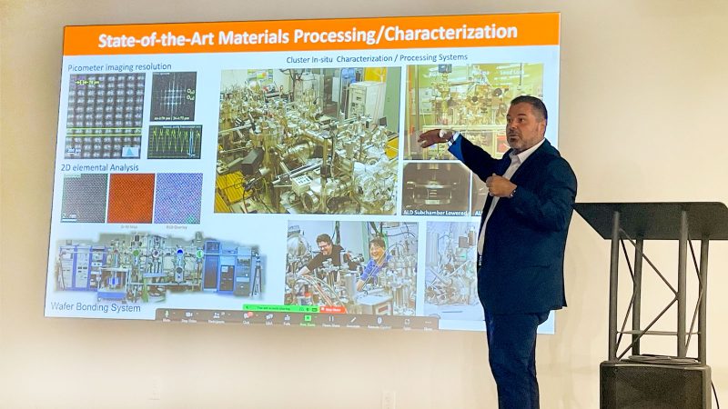 Dr. Manuel Quevedo is pointing to a screen slide a out state-of-the-art materials processing.